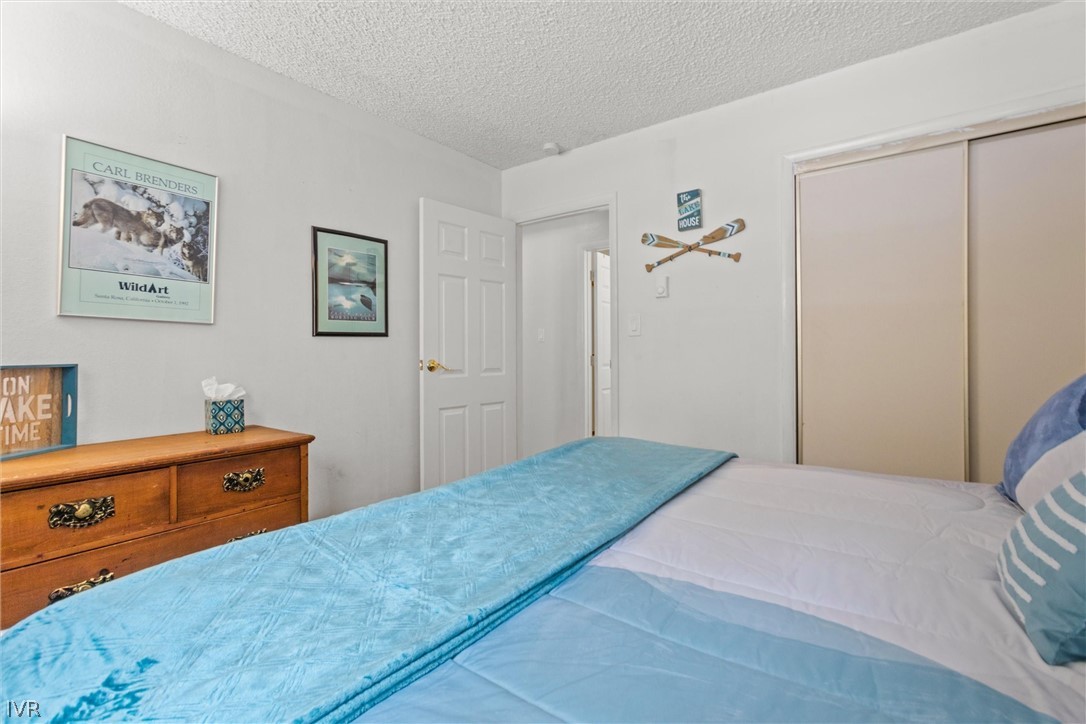 321 Ski Way, Unit 13 Incline Village, NV 89451 - Photo 17 of 26 a bedroom with a bed and a lamp on the dresser