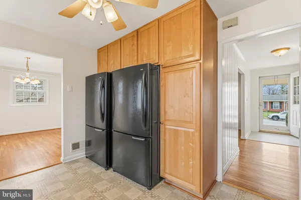 a metallic refrigerator freezer sitting in a kitchen