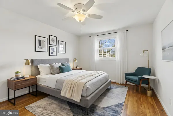 a spacious bedroom with a bed and a table in it