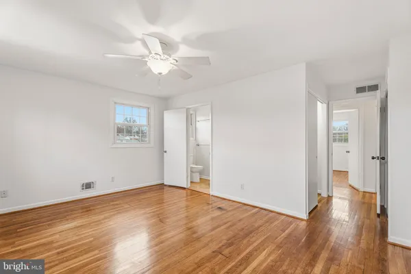 a bedroom with a bed and a potted plant