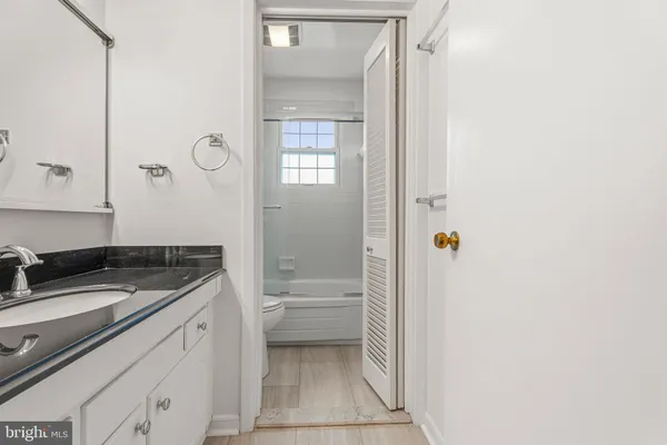 a bathroom with a toilet and a bathtub