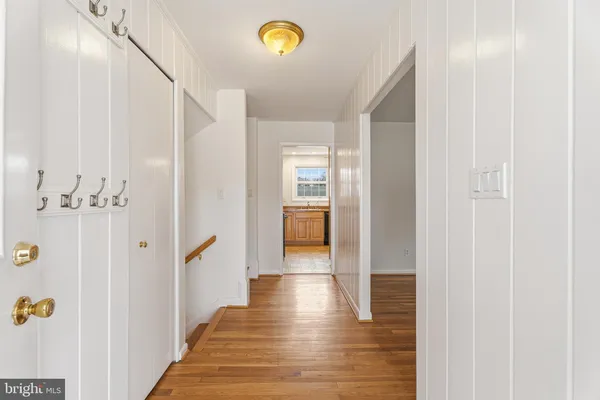 a view of a hallway with wooden floor