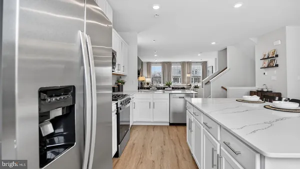 a kitchen with a sink stainless steel appliances and cabinets