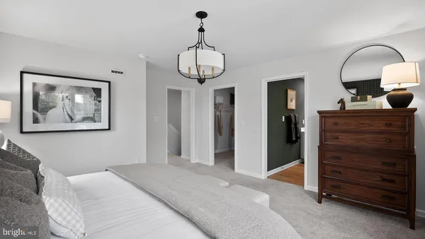 a bedroom with a bed and cabinets