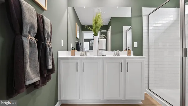 a bathroom with a double vanity sink and a mirror