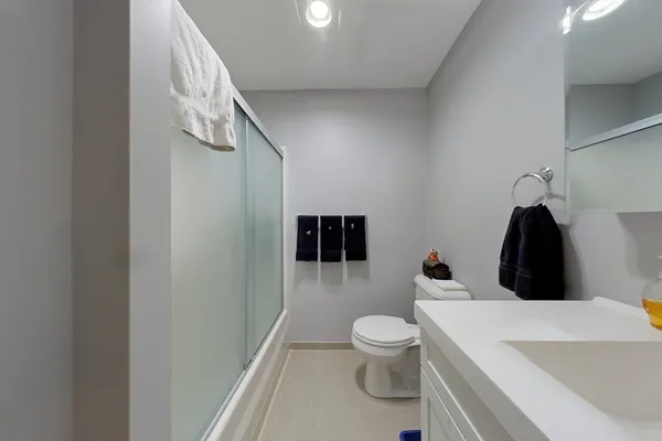 a bathroom with a toilet and a shower