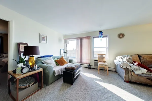 a bedroom with furniture and a flat screen tv