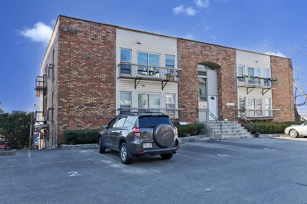 a car parked in front of a brick building
