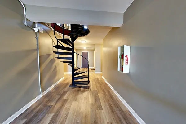 a view of entryway with stairs and wooden floor