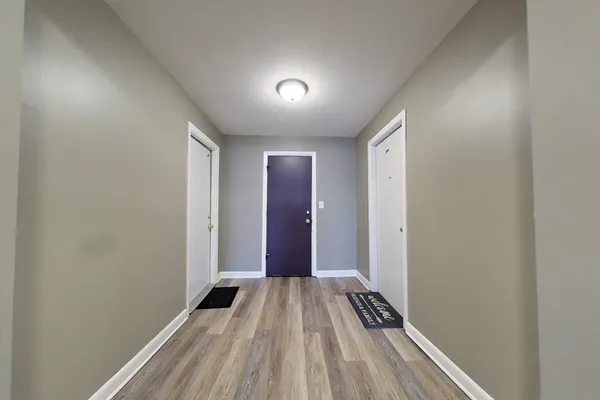 a view of a room with wooden floor