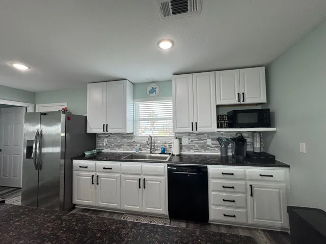 a kitchen with stainless steel appliances granite countertop a stove and a refrigerator