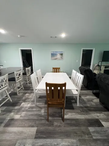 a living room with lots of furniture and kitchen view