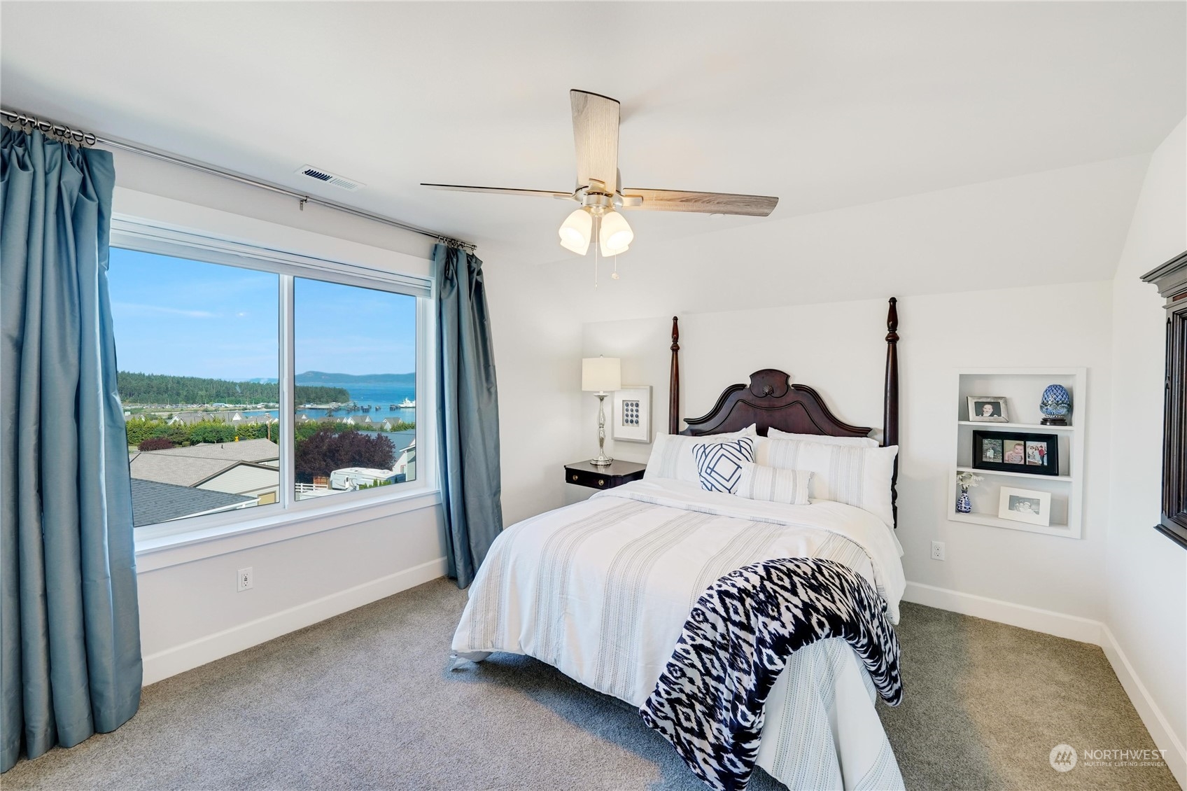 1520 Latitude Circle Anacortes, WA 98221 - Photo 24 of 35 a bedroom with a large bed and a chandelier