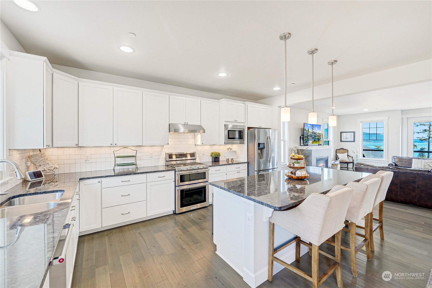 1520 Latitude Circle Anacortes, WA 98221 - Photo 9 of 35 a kitchen with white cabinets and stainless steel appliances