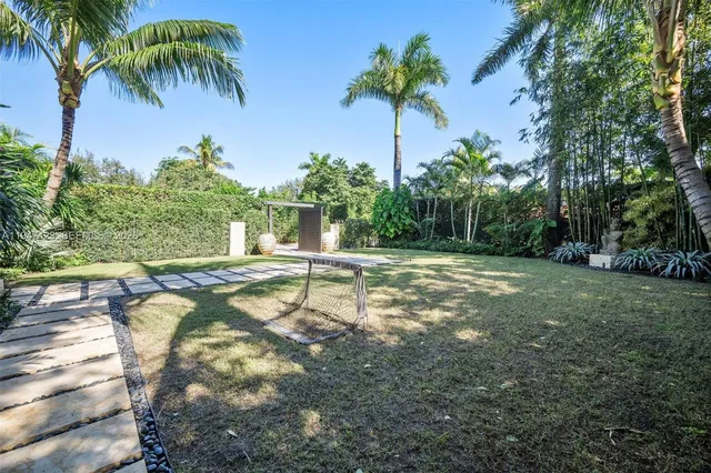 a backyard of a house with table and chairs