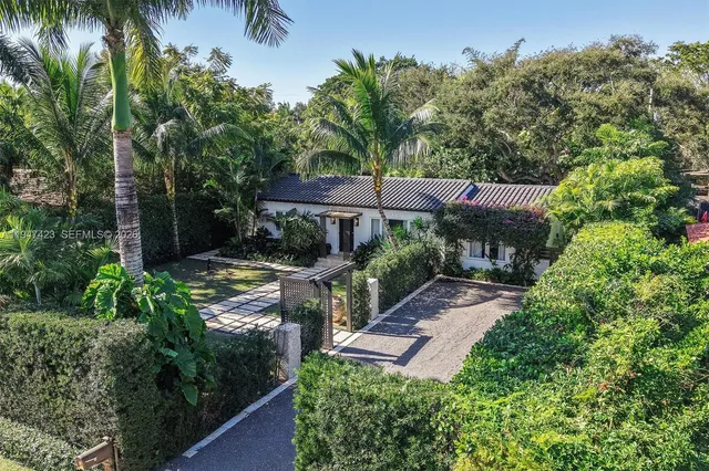 an aerial view of house with yard and outdoor seating