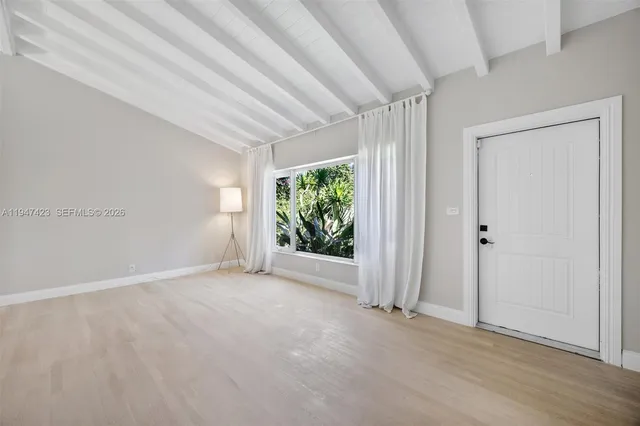 an empty room with windows and closet