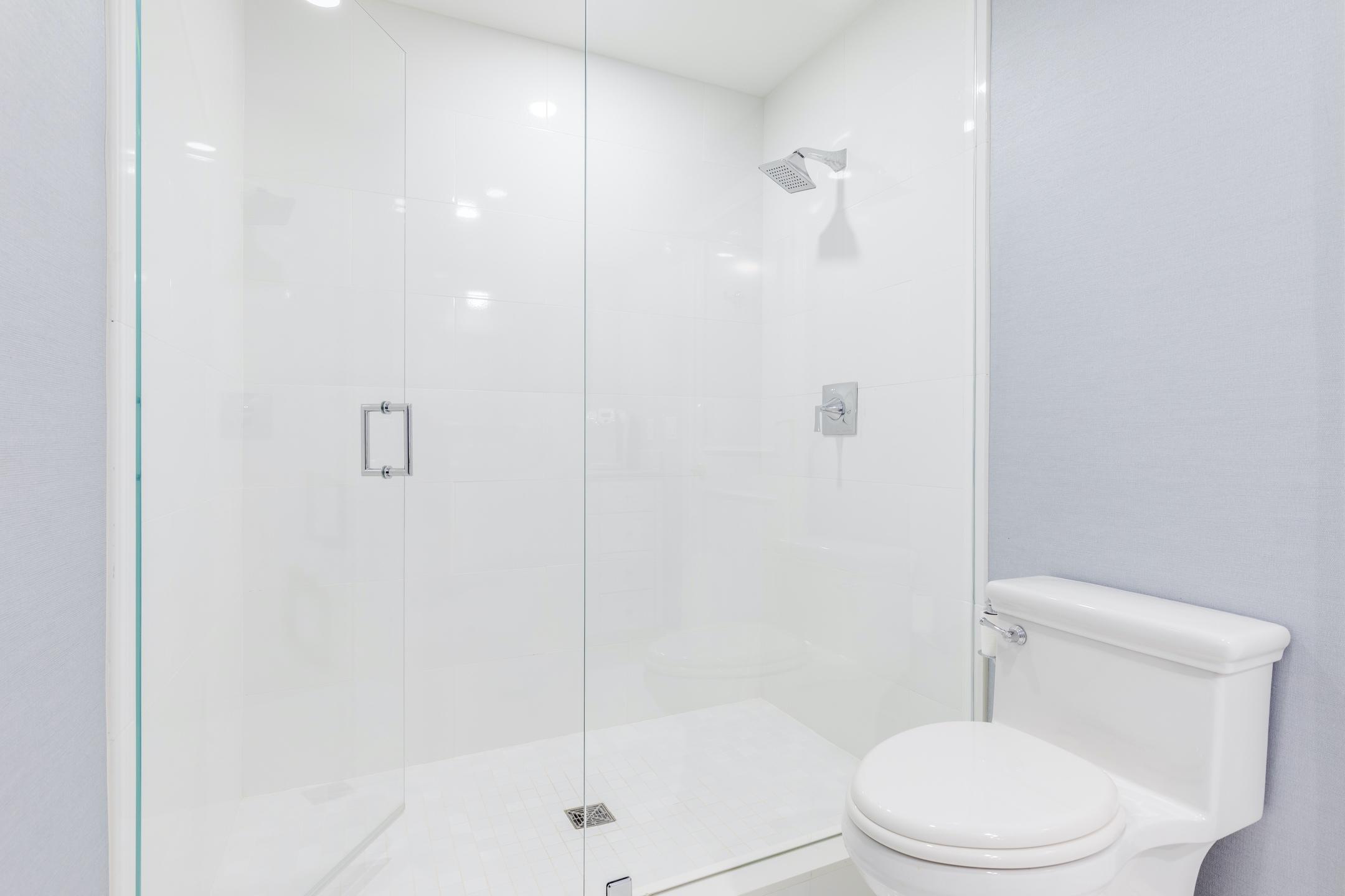 2050 Florida A1A, Unit 3 Jupiter, FL 33477 - Photo 14 of 36 a white toilet next to a bathroom