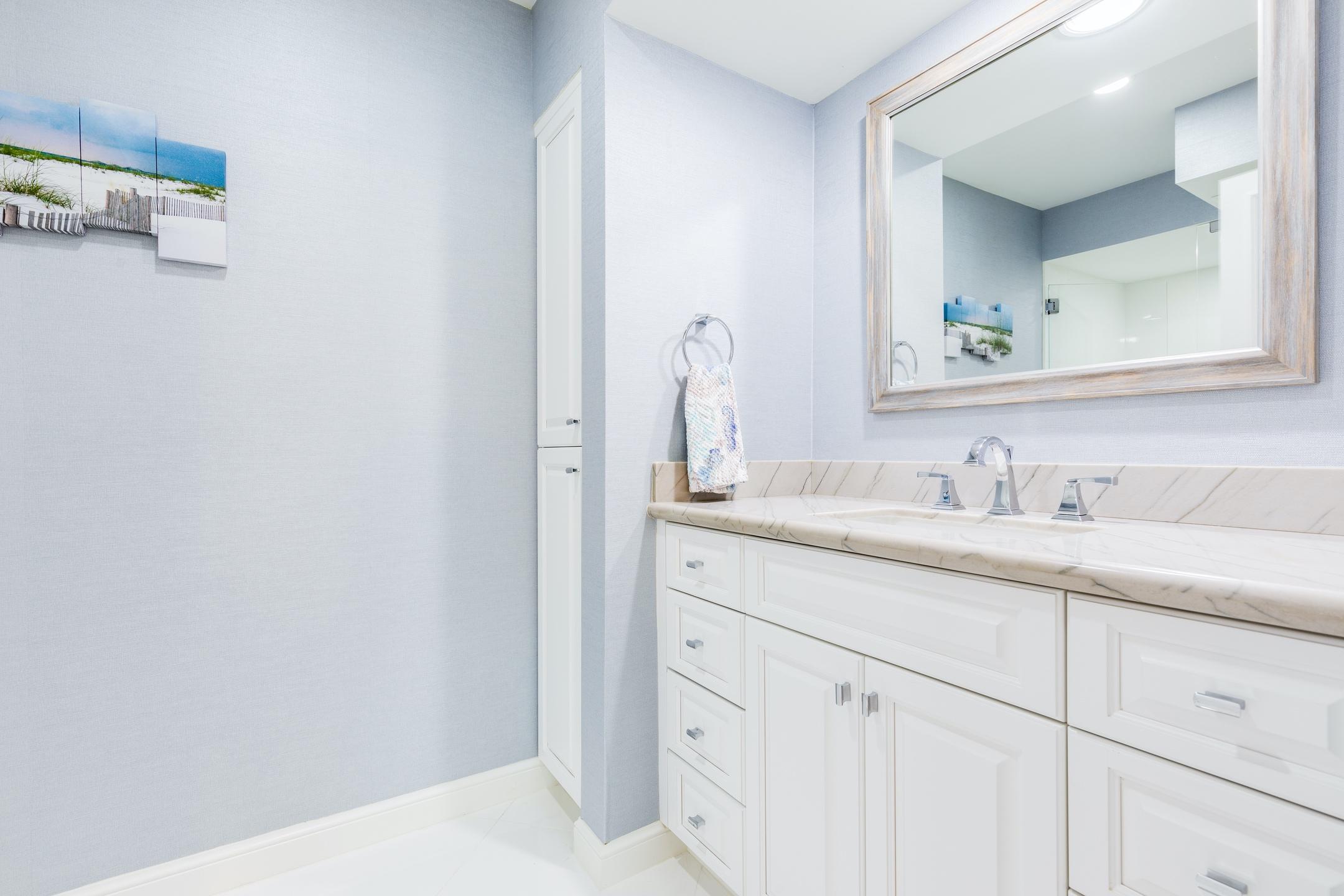 2050 Florida A1A, Unit 3 Jupiter, FL 33477 - Photo 15 of 36 a bathroom with a sink and a mirror