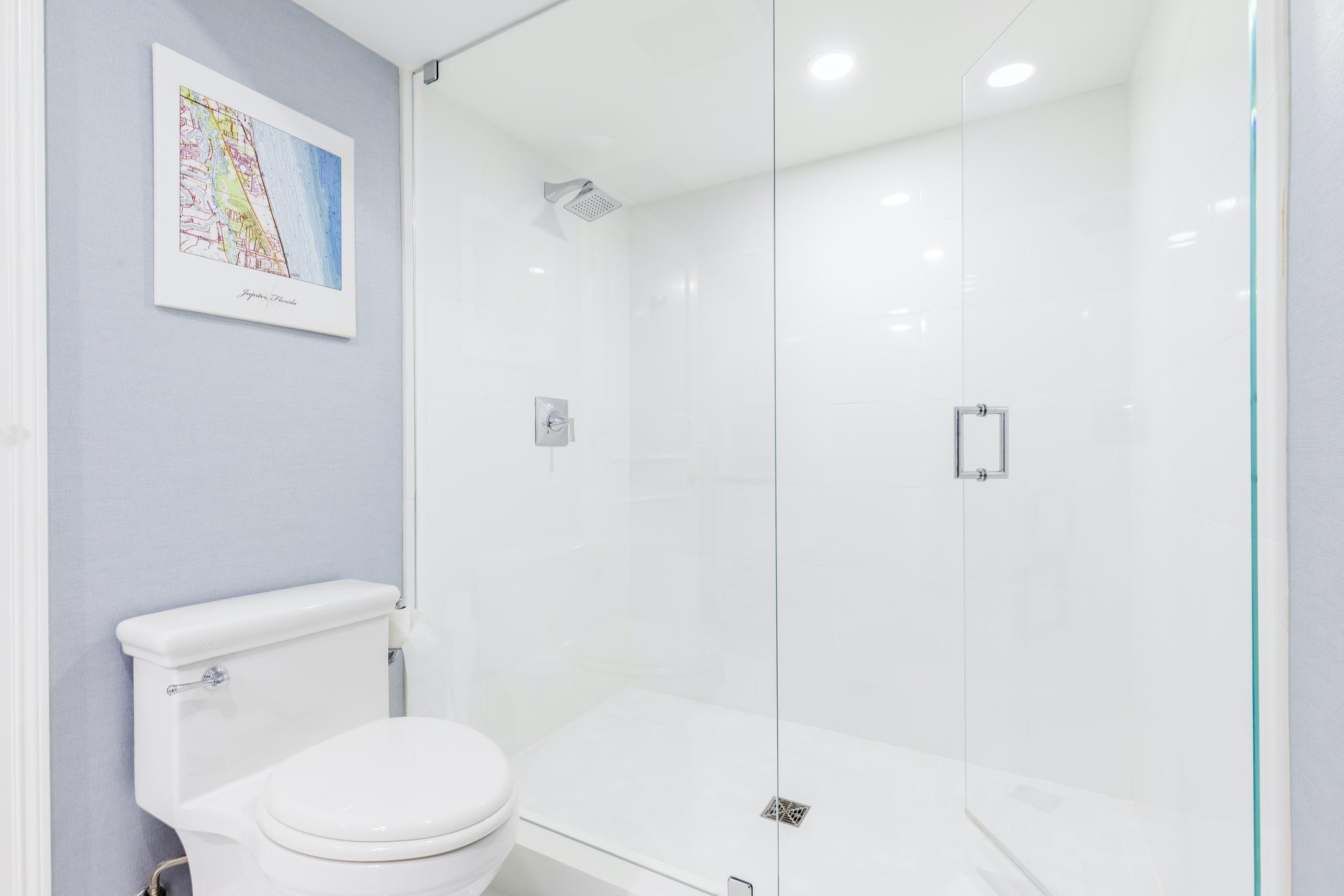 2050 Florida A1A, Unit 3 Jupiter, FL 33477 - Photo 16 of 36 a white toilet sitting next to a shower