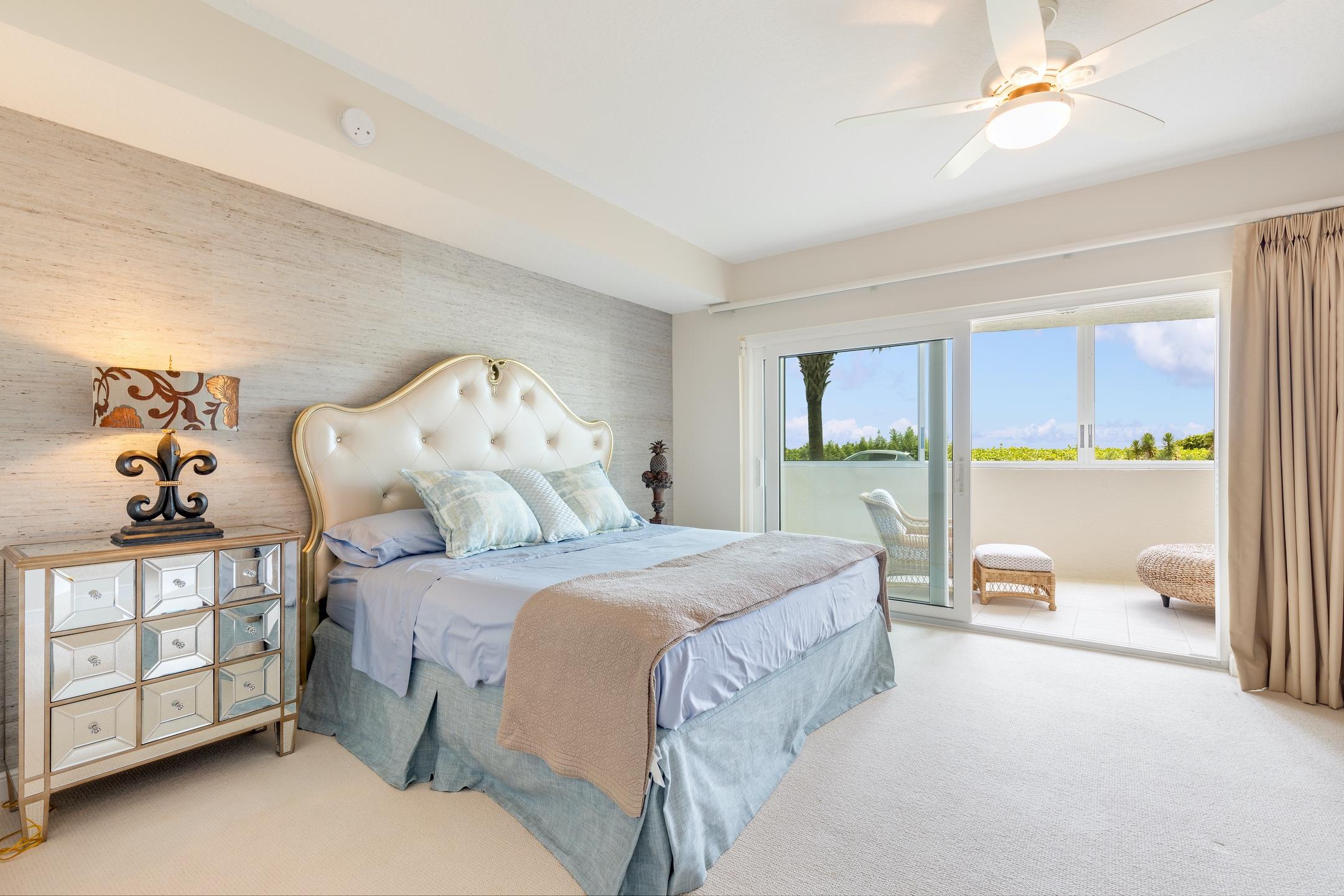 2050 Florida A1A, Unit 3 Jupiter, FL 33477 - Photo 17 of 36 a spacious bedroom with a bed and a large window