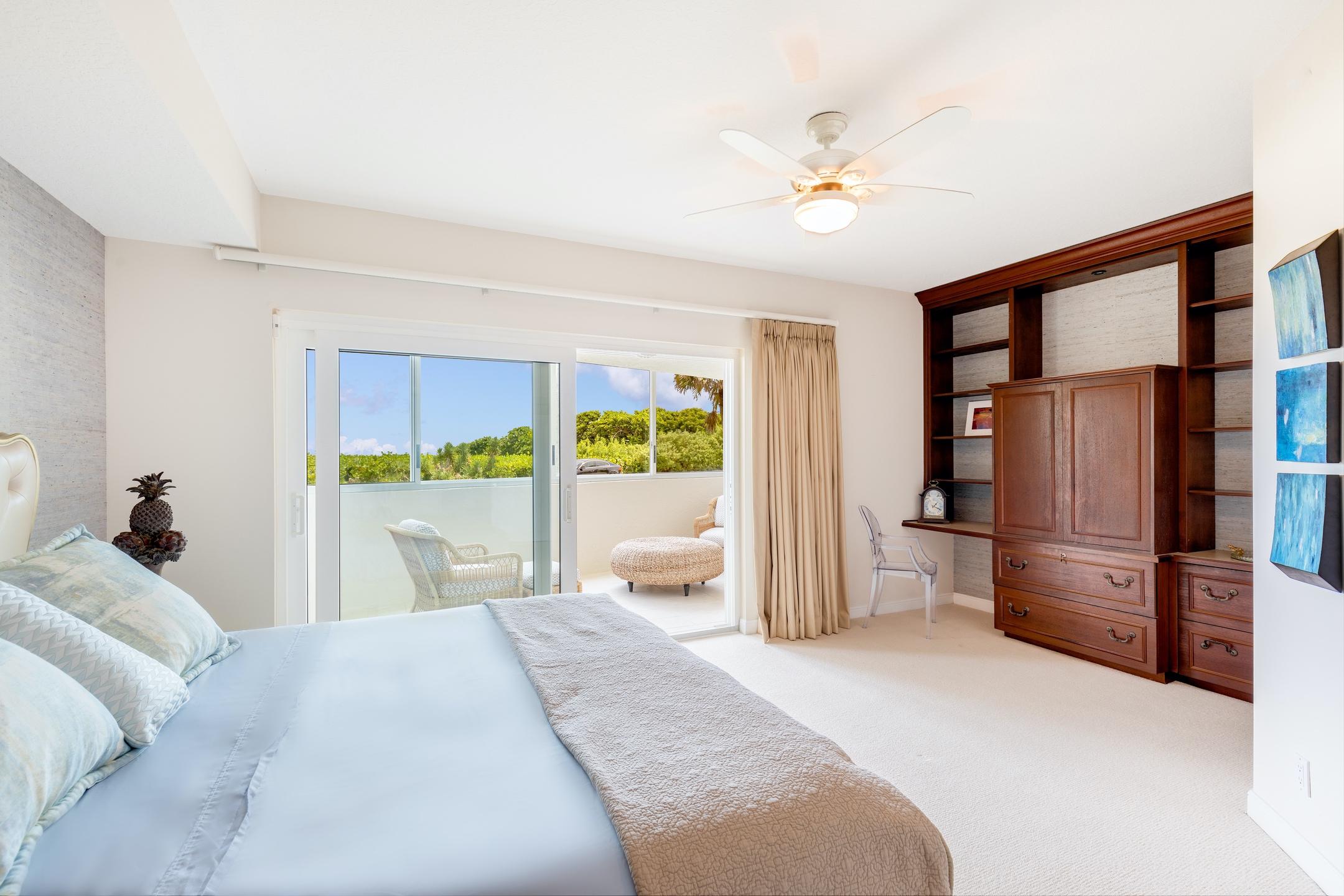 2050 Florida A1A, Unit 3 Jupiter, FL 33477 - Photo 18 of 36 a bedroom with a large bed and a large window