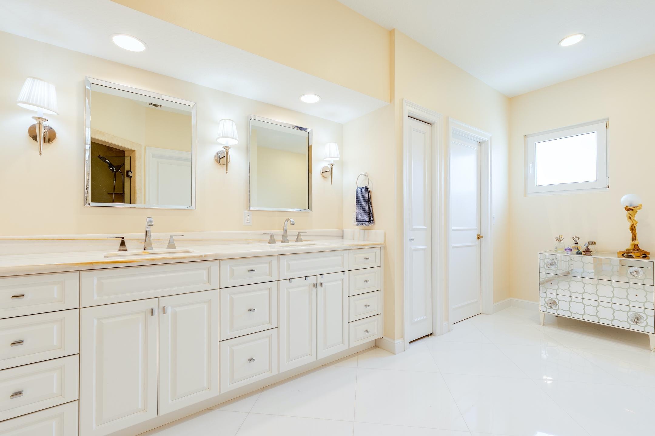 2050 Florida A1A, Unit 3 Jupiter, FL 33477 - Photo 25 of 36 a spacious bathroom with 2 sink tub and a mirror