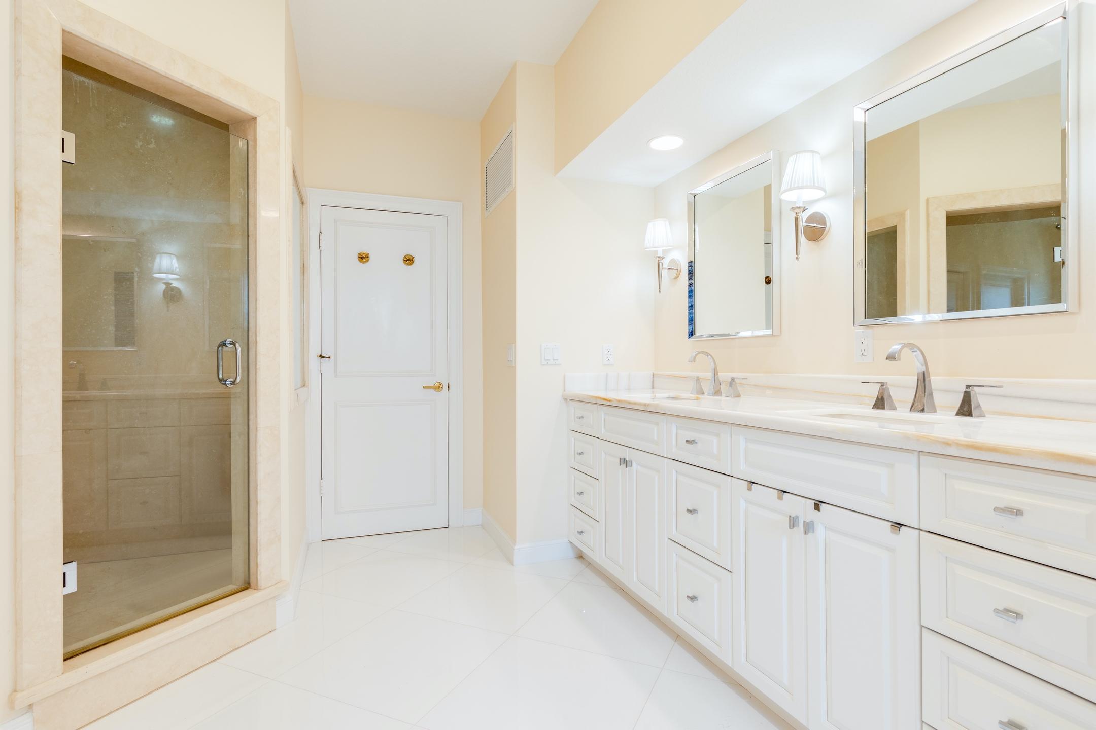 2050 Florida A1A, Unit 3 Jupiter, FL 33477 - Photo 27 of 36 a bathroom with a granite countertop sink mirror and