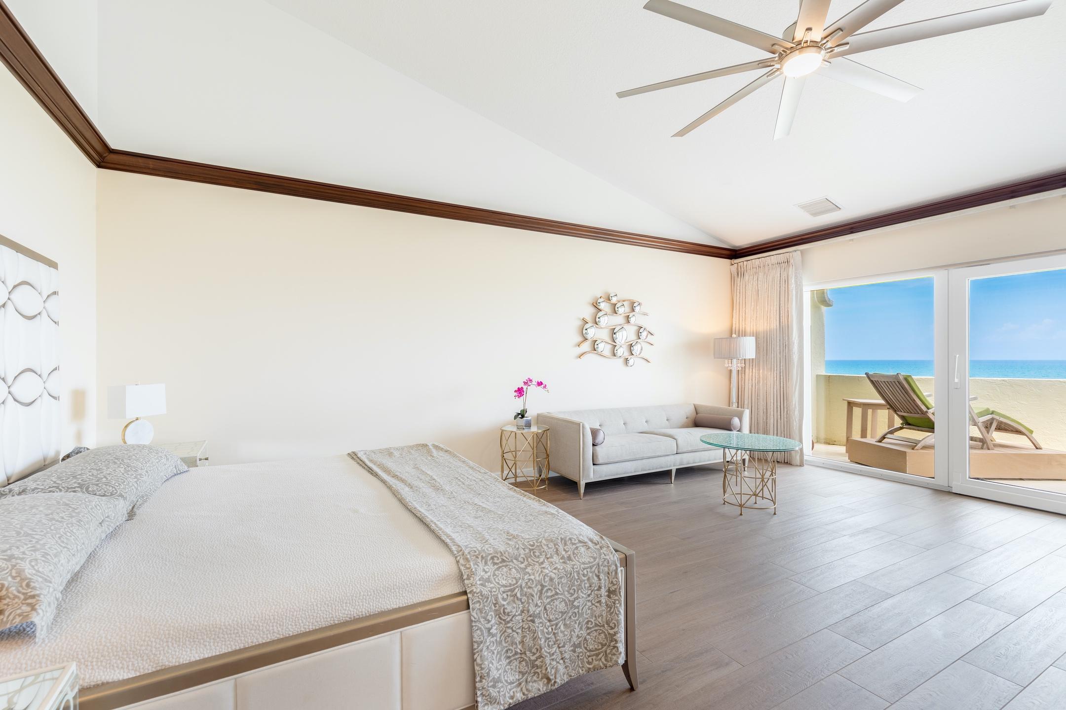 2050 Florida A1A, Unit 3 Jupiter, FL 33477 - Photo 29 of 36 a bedroom with a bed and wooden floor