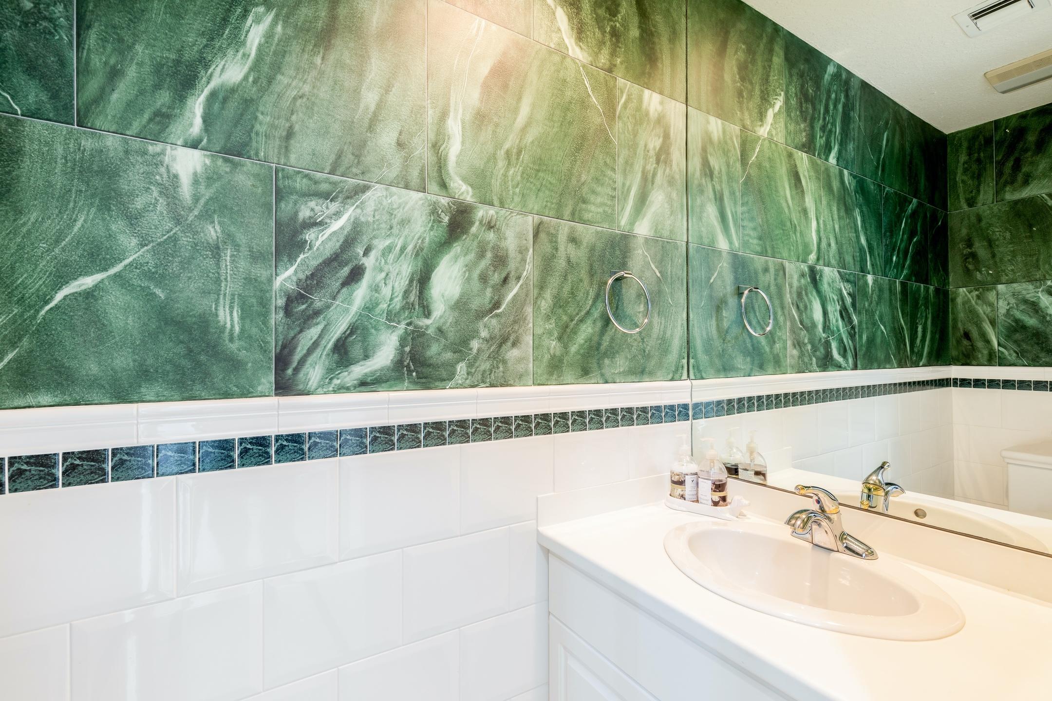 2050 Florida A1A, Unit 3 Jupiter, FL 33477 - Photo 31 of 36 a bathroom with a sink and mirror