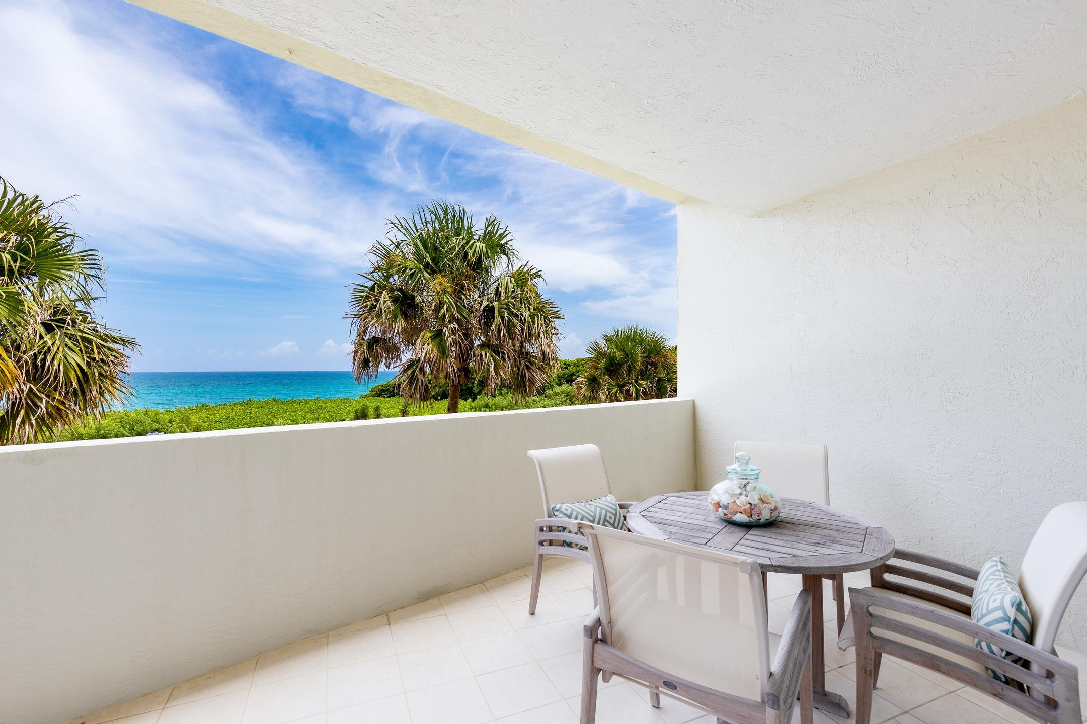 2050 Florida A1A, Unit 3 Jupiter, FL 33477 - Photo 32 of 36 a view of table and chairs in patio
