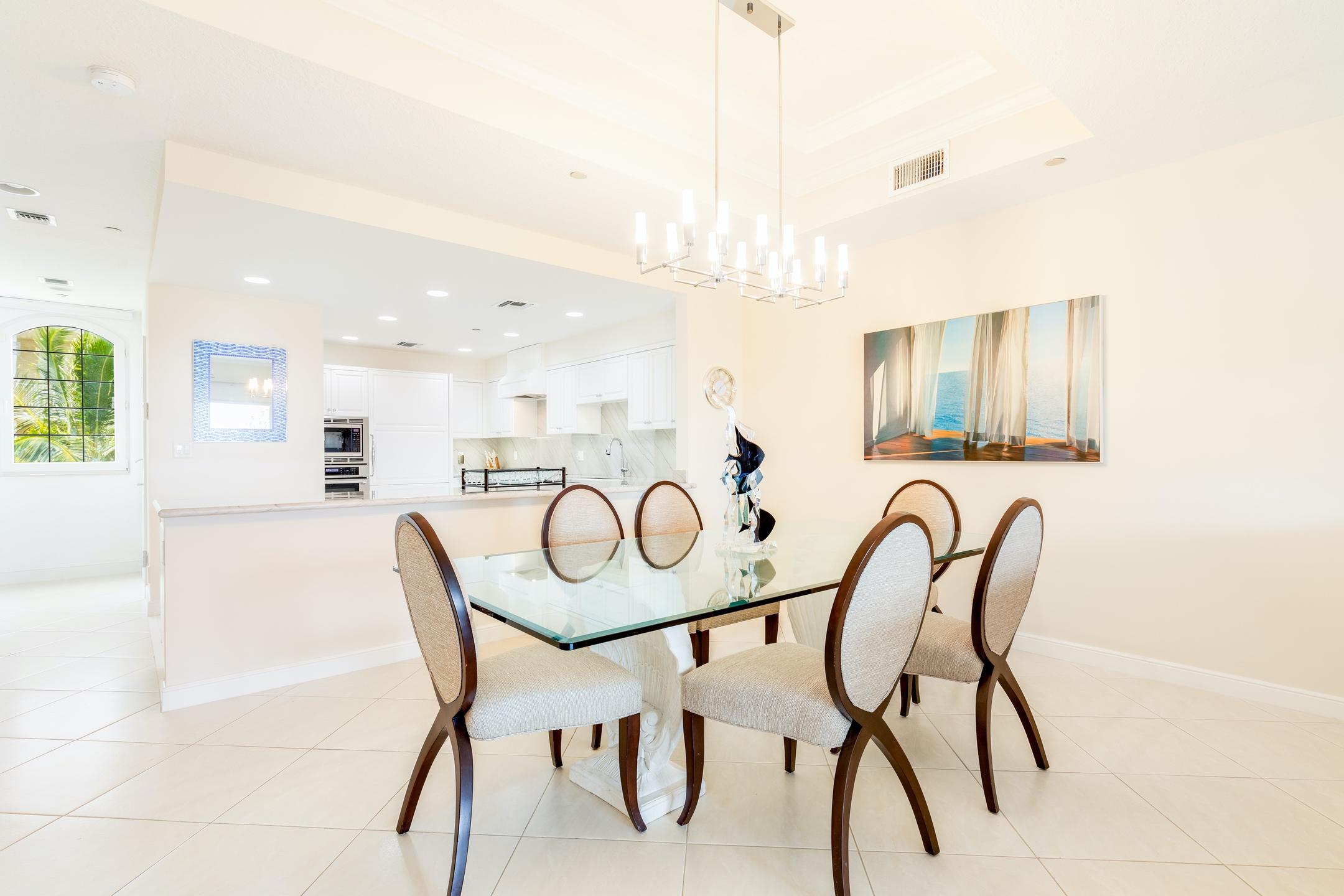 2050 Florida A1A, Unit 3 Jupiter, FL 33477 - Photo 9 of 36 a dining room with furniture and a floor to ceiling window