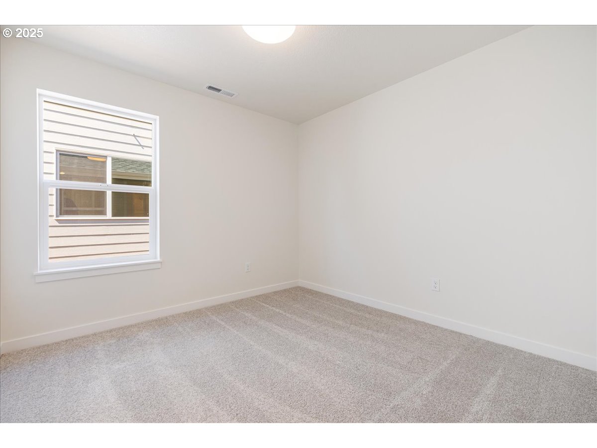 1449 Southeast Hankel Street Dallas, OR 97338 - Photo 12 of 19 a view of an empty room with a window