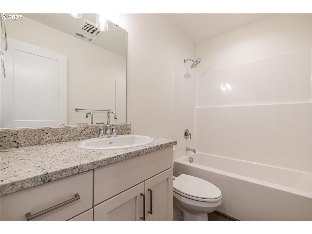 1449 Southeast Hankel Street Dallas, OR 97338 - Photo 14 of 19 a bathroom with a granite countertop sink toilet and shower