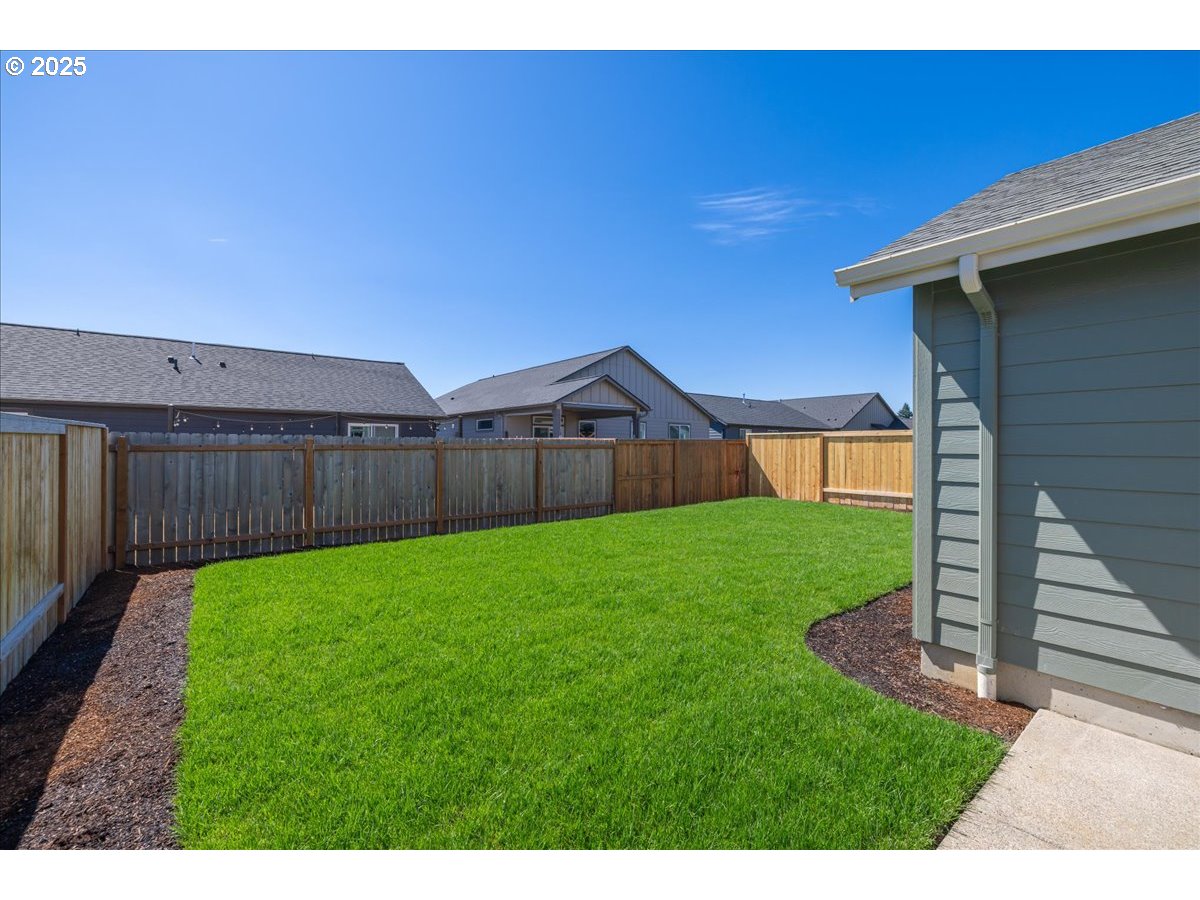 1449 Southeast Hankel Street Dallas, OR 97338 - Photo 16 of 19 a view of a backyard with wooden fence