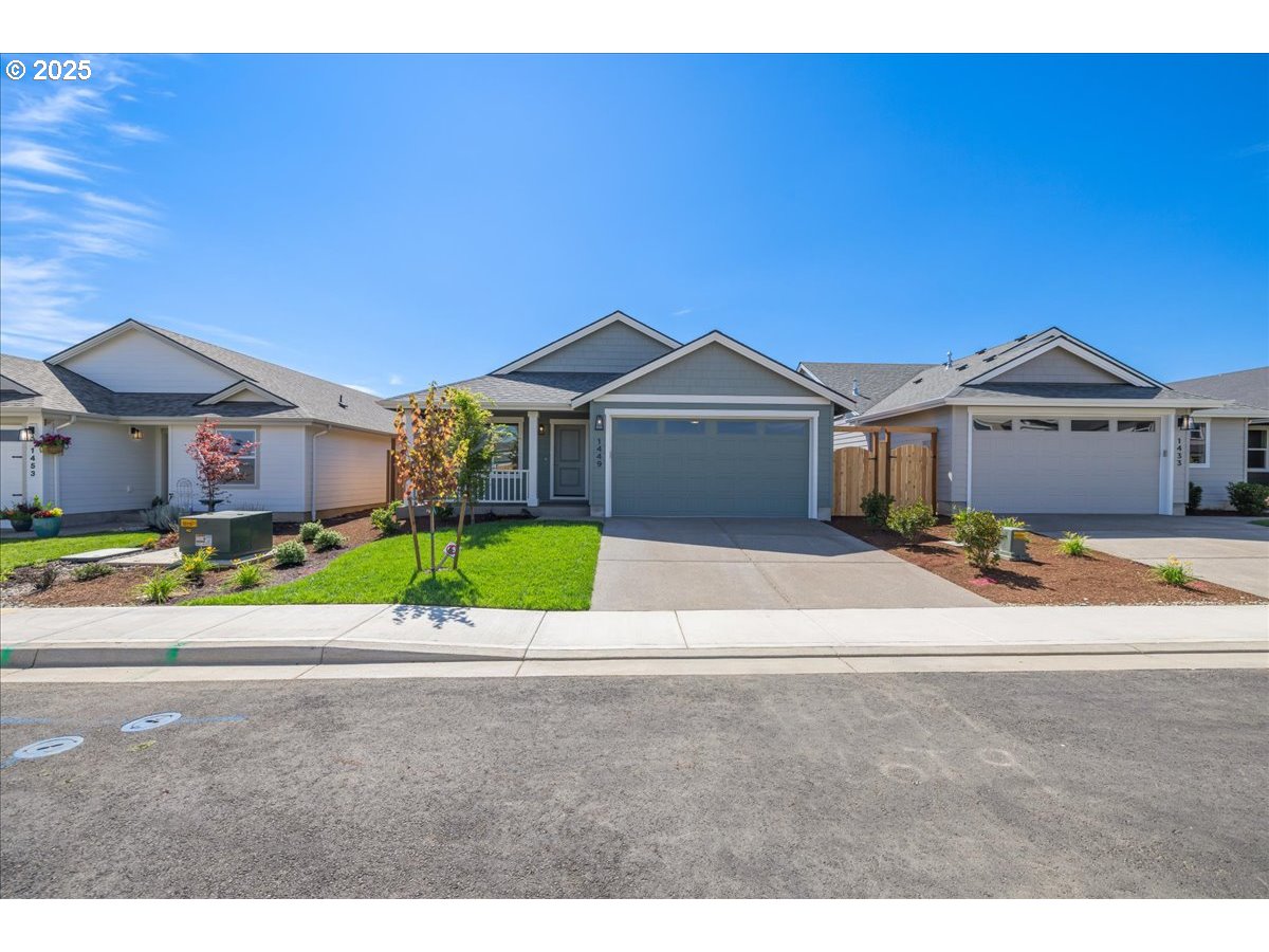 1449 Southeast Hankel Street Dallas, OR 97338 - Photo 17 of 19 a front view of a house with a yard and potted plants