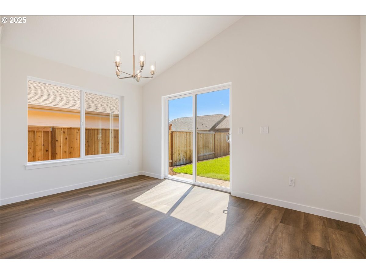 1449 Southeast Hankel Street Dallas, OR 97338 - Photo 7 of 19 a view of an empty room with a window and wooden floor