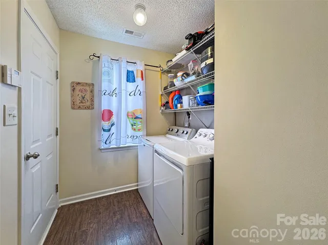 a spacious bedroom with a bed and a flat screen tv