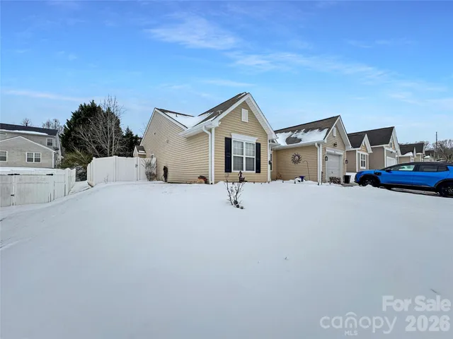 a front view of a house with cars parked