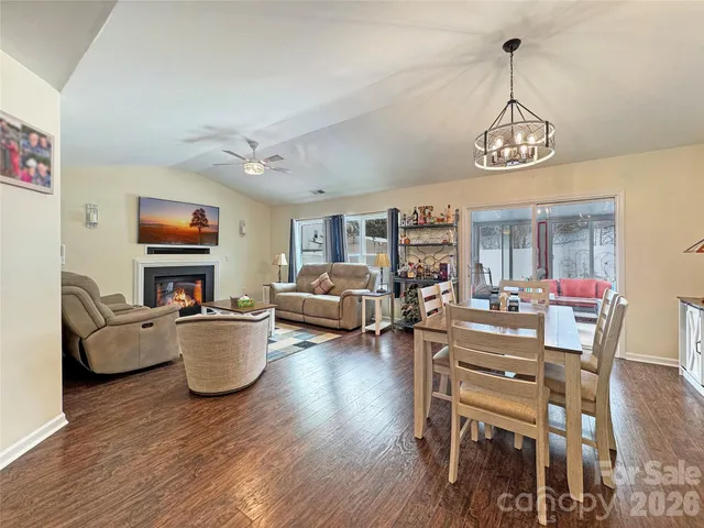 a living room with fireplace furniture and a chandelier