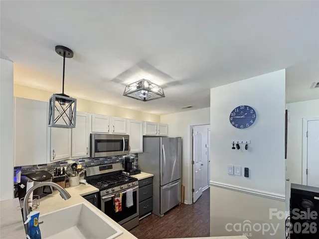 a view of a kitchen with refrigerator and microwave