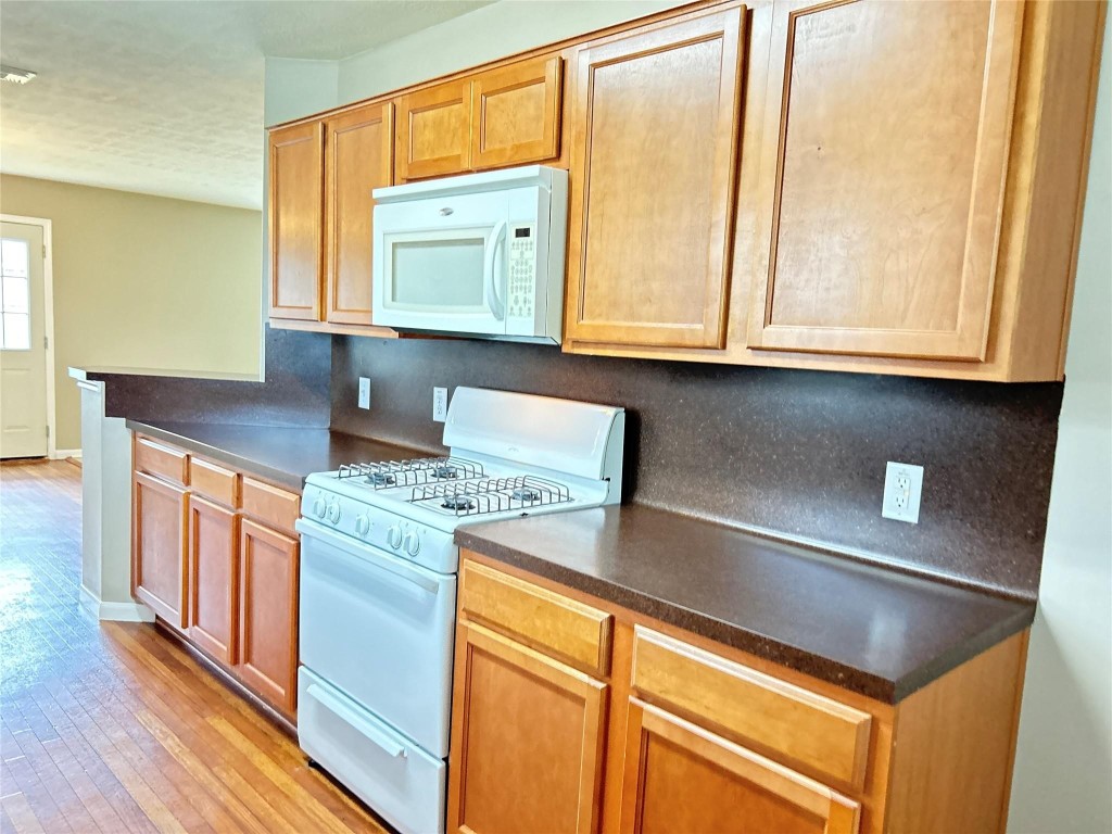 8103 Katie Mill Trail Spring, TX 77379 - Photo 14 of 36 a kitchen with stainless steel appliances granite countertop a sink and cabinets