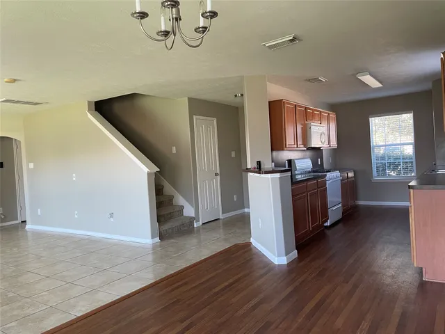 a kitchen with stainless steel appliances granite countertop a sink stove and cabinets