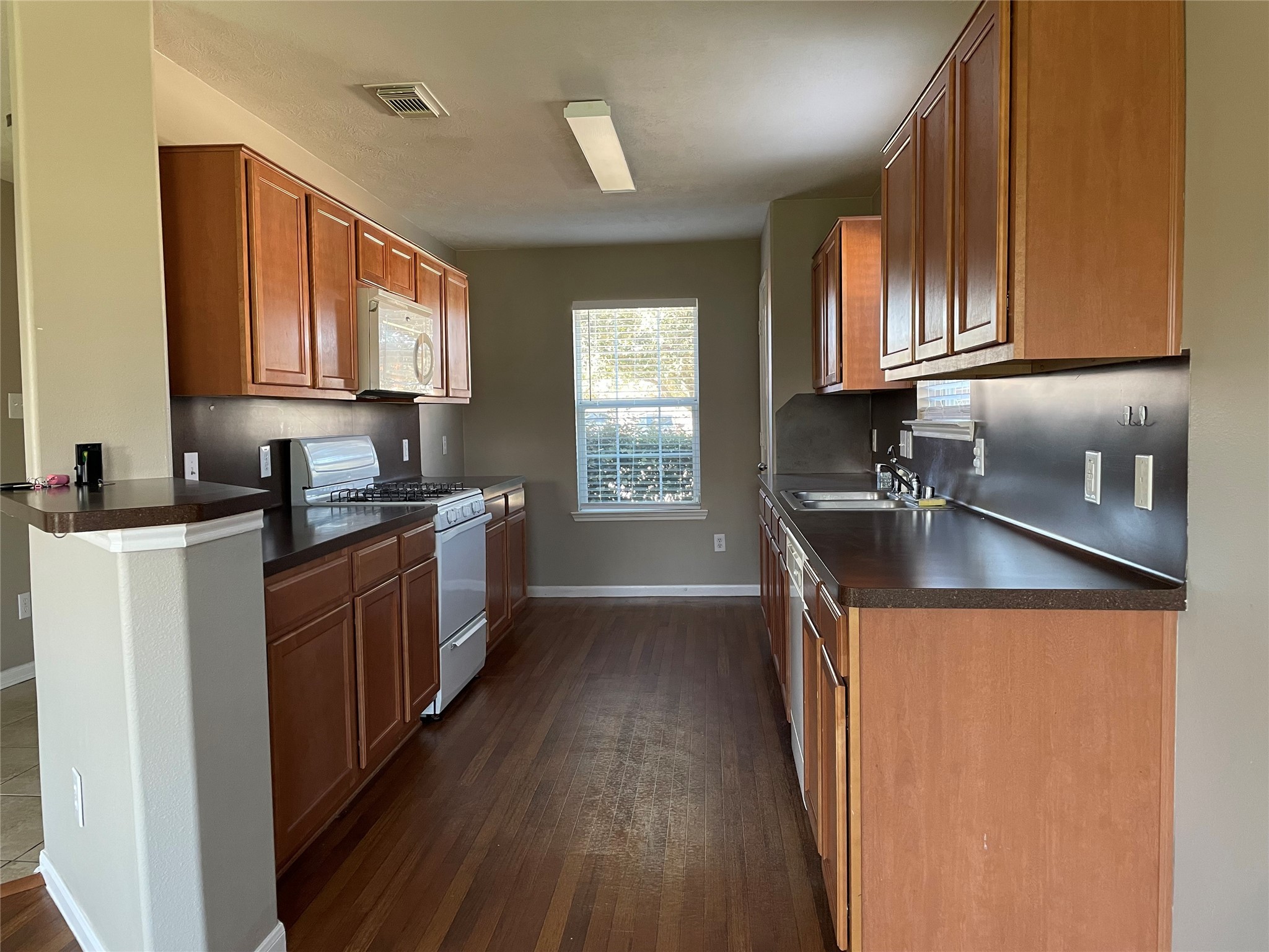 8103 Katie Mill Trail Spring, TX 77379 - Photo 17 of 36 a kitchen with stainless steel appliances granite countertop a sink stove and cabinets