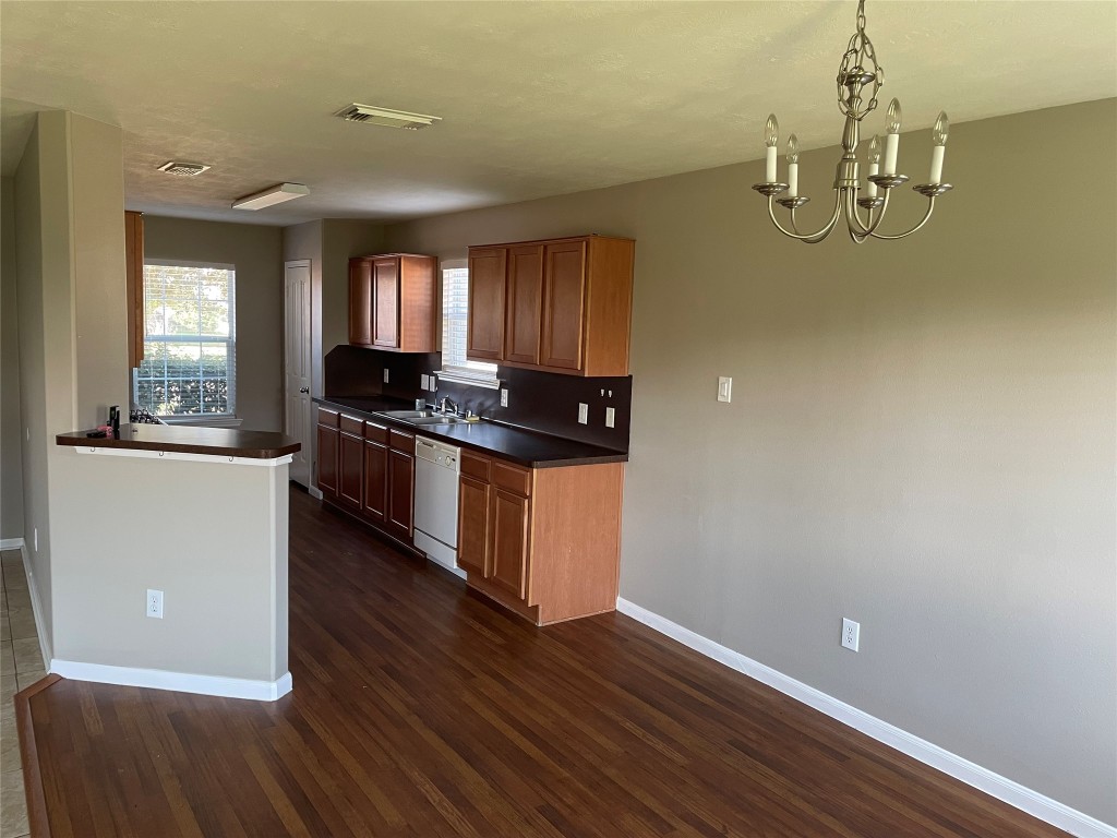 8103 Katie Mill Trail Spring, TX 77379 - Photo 21 of 36 a kitchen with granite countertop a stove and a wooden floors