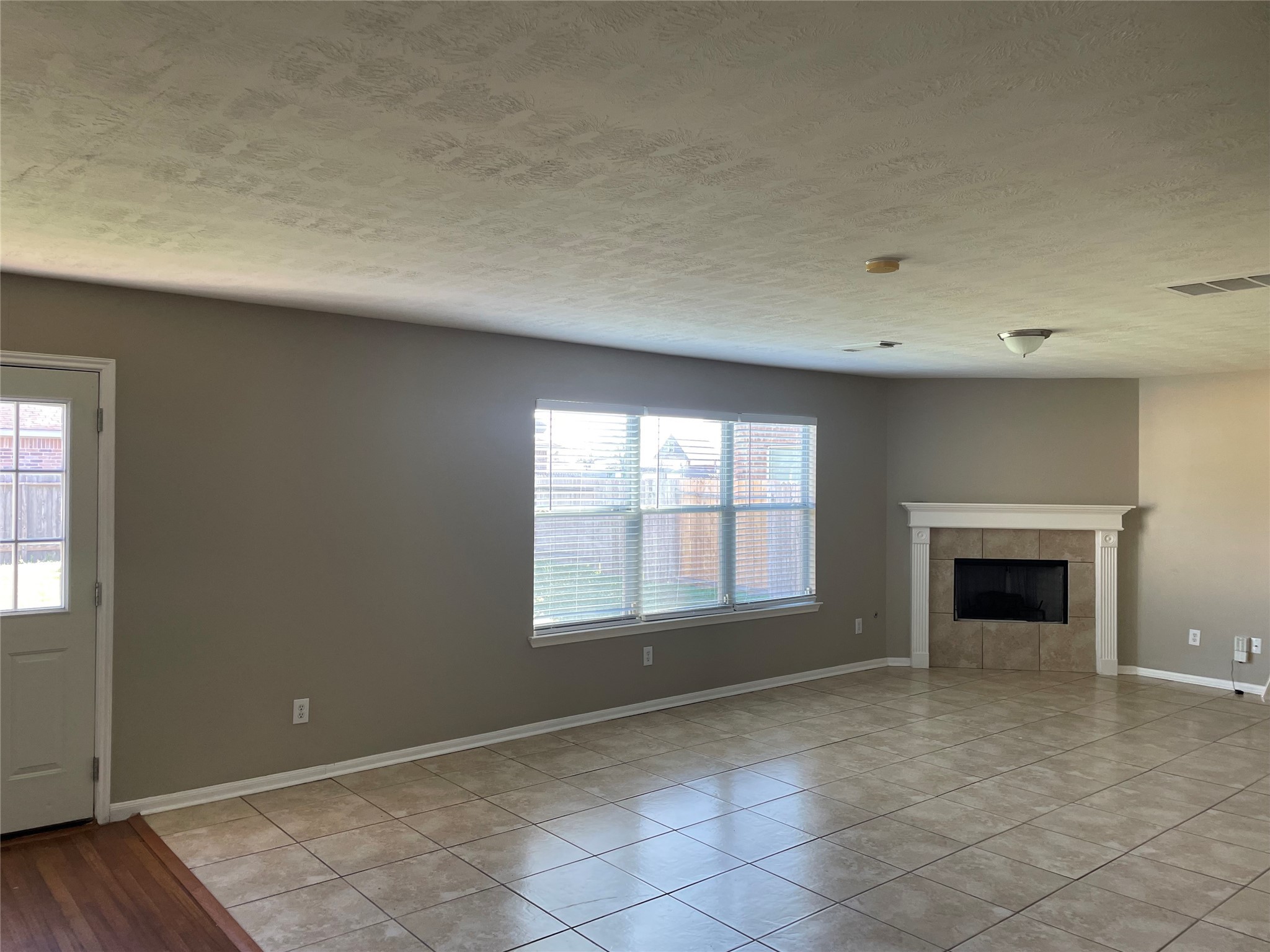 8103 Katie Mill Trail Spring, TX 77379 - Photo 10 of 36 an empty room with windows and fireplace