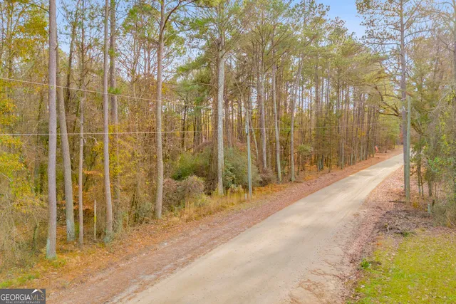 a view of wooden fence and trees