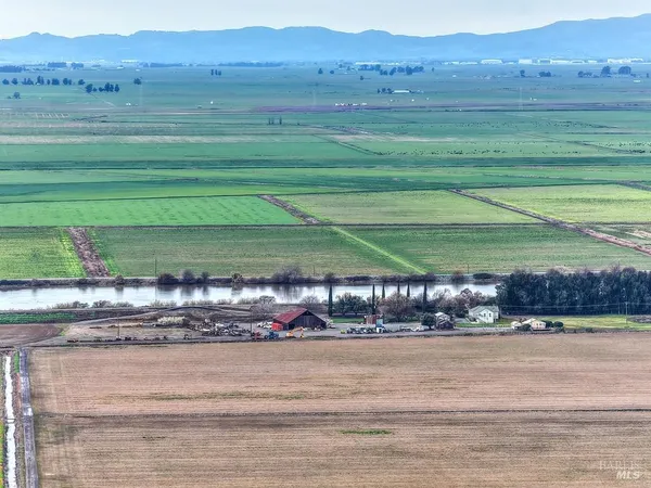 a yard with pier lake view and houses in the back