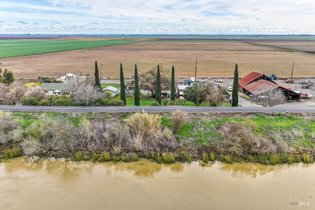 3834 Highway 84 Walnut Grove, CA 95690 - Photo 28 of 84 a view of a lake with a big yard and large trees