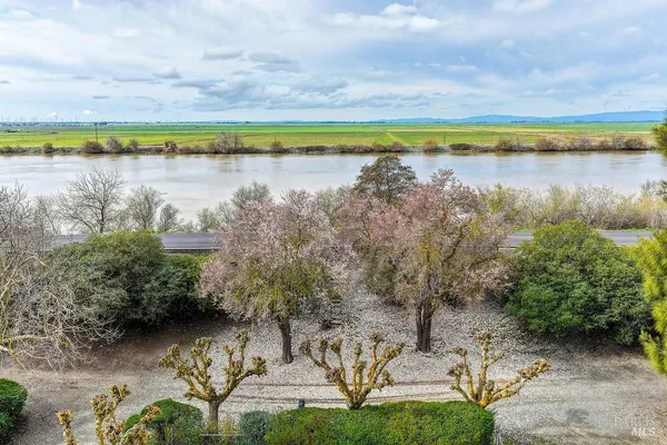a living room with furniture a rug and white walls